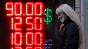 A sign displays foreign currency exchange rates in Moscow this week. The ruble has plunged in face of the economic sanctions put on Russia.