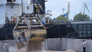 Workers load grain at a grain port in Izmail, Ukraine, in April.