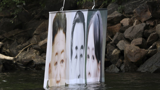 A banner attached to a balloon with images of North Korean leader Kim Jong-un, the late leader Kim Il-sung, and Kim Yo-jong, released by Fighters For Free North Korea, in Hongcheon, South Korea, on Tuesday. The North has repeatedly warned it would retaliate against leaflets and other information being distributed over the border. 