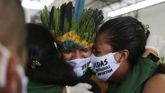 Relatives cry during the funeral of Kokama Chief Messias Martins Moreira, who died of COVID-19, during his burial service at the Park of Indigenous Nations in Manaus, Brazil. 