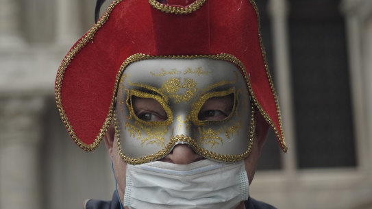 A Russian tourist dons a carnival mask and protective mask for Carnival. The event was cancelled two days before it was due to finish. 