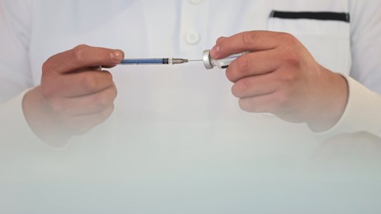 A nurse prepares a syringe with doses of the COVID-19 AstraZeneca vaccine.
