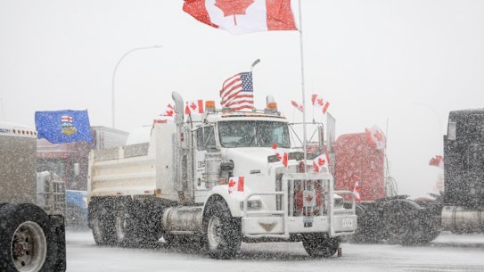 Anti-COVID-19 vaccine mandate demonstrators gather as a truck convoy blocks the highway at the busy U.S. border crossing in Coutts, Alberta, Canada.