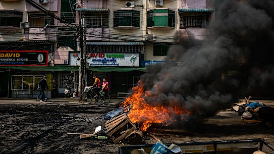 Tyres are set alight by anti-coup protesters at a blockade in Yangon.