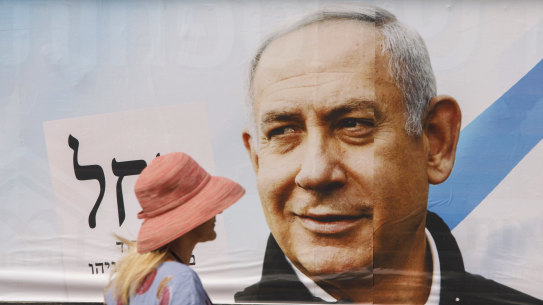 A pedestrian passes a campaign billboard for Israeli Prime Minister Benjamin Netanyahu in Tel Aviv.