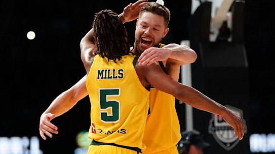 Patty Mills and Andrew Dellavedova celebrate Australia's shock win over the USA.