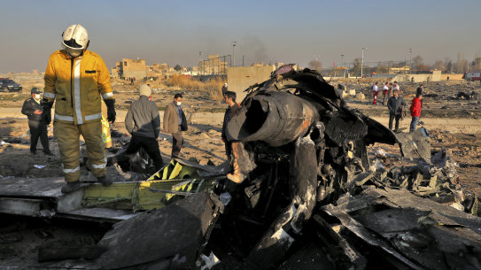 Rescue workers search the scene where a Ukrainian plane crashed in Shahedshahr, near the Iranian capital Tehran on Wednesday.