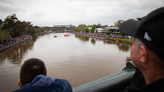 Very far away ... disappointed AFL fans on the Princes Bridge during the parade.