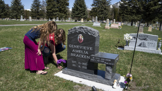 Ashley Bracken and one of her other daughters, Juliet, visit the grave of Genevieve, who died by suicide at the age of 14.