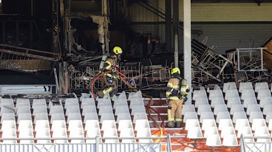 Firefighters inspect the damage at Caulfield Racecourse.