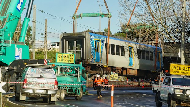 A train carriage is removed from the tracks after derailing in Clifton Hill.