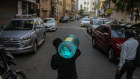 A man carries water jar during a lockdown in Mumbai, India, on Tuesday. 