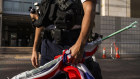 A Hong Kong police officer holds a British flag brought by a pro-democracy activist known as “Grandma Wong”, outside the West Kowloon courts last month.