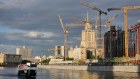 Home building: A ship floats along the Moskva river past a construction site of a new apartment complex in front of the Russian Government’s main building and a Stalin-era skyscraper in Moscow, Russia. 