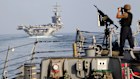 The aircraft carrier USS Dwight D. Eisenhower and other warships cross the Strait of Hormuz into the Persian Gulf.