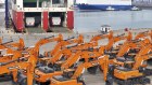 Engineering vehicles for export wait for transportation from a port in Yantai in eastern China’s Shandong province.