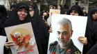 Protesters in Tehran hold up posters of General Qassem Soleimani while mourning during a demonstration over the US airstrike in Iraq. 
