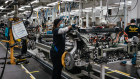 Workers assemble components for EV pickup trucks in Illinois.