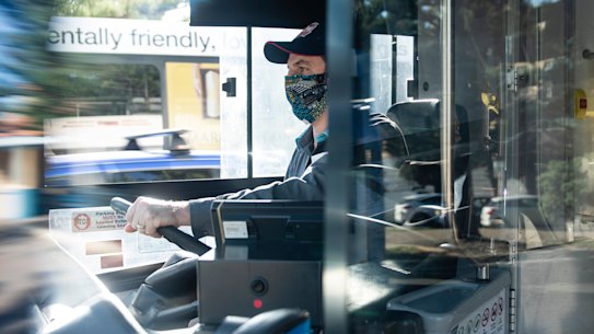 A NSW bus driver wears a homemade face mask. 