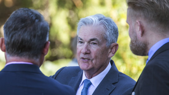 Federal Reserve Chair Jerome Powell, center, takes a coffee break with attendees of the central bank’s annual symposium at Jackson Hole.