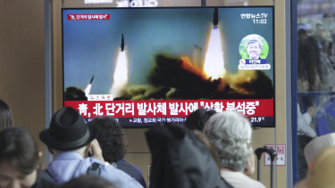 People watch a TV showing a file footage of North Korea's missile launch in Seoul on Saturday.