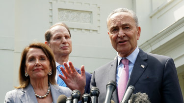 Senate Minority Leader Chuck Schumer, a Democrat from New York, right, speaks to members of the media as US House Speaker Nancy Pelosi, a Democrat from California, left, smiles after a meeting with US President Donald Trump at the White House in Washington, DC. 
