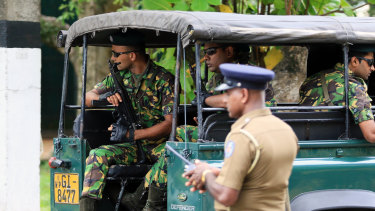 Special Task Force (STF) police officers sit in a vehicle arriving at the Parliament of Sri Lanka in Colombo.