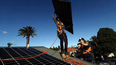 Solar panels being installed on a rooftop in Sydney. 