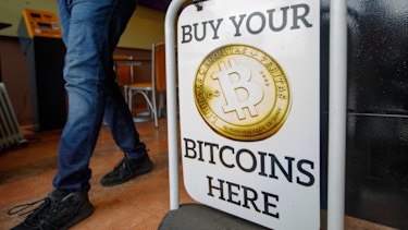 A sign advertising a bitcoin automated teller machine at a cafe in London.