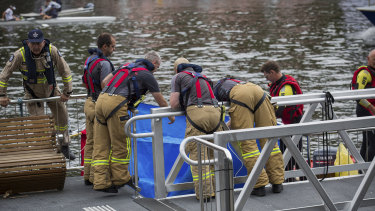 Emergency workers remove the body from the Yarra River.