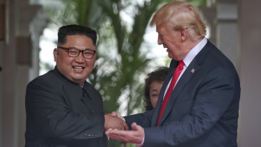 Donald Trump and Kim Jong-un shake hands in Singapore.