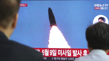 South Koreans watch a TV showing a report of a North Korea missile launch.