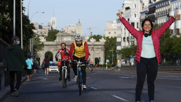 People running and cycling through Madrid's Puerta de Alcala on the first day since Spain eased the COVID-19 lockdown measures to allow exercise.