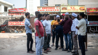 Rakesh Maheriya, third from right, who is president of a street vendor association, meets with fellow vendors in Ahmedabad, India.