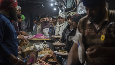 People line up for free food at the farmers protest in Singhu on the border with Delhi.