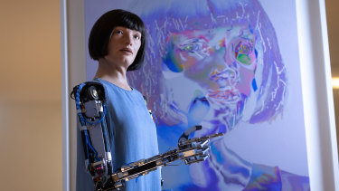 Ai-Da stands in front of one of ‘her’ artworks during “Ai-Da: The World’s First Robot Artist” press view at Design Museum in London, England.  AI-DA is on display until August 29, 2021 at The Design Museum