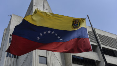 The Venezuelan flag flies outside the Supreme Court building in Caracas, Venezuela.