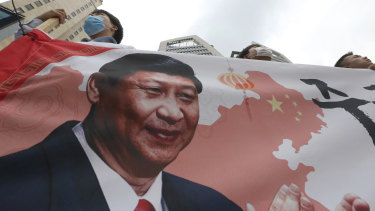 South Korean protesters with an image of Chinese President Xi Jinping stage a rally to denounce the South Korean government's policy on China on Wednesday.