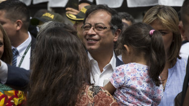 Gustavo Petro, presidential candidate for the Progressivists Movement Party, centre, arrives to cast his ballot in Bogota.