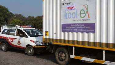 A cold storage haulage truck containing Covid-19 vaccines stops while being escorted by police from the cargo section of the Indira Gandhi International Airport to Haryana, in New Delhi, India.