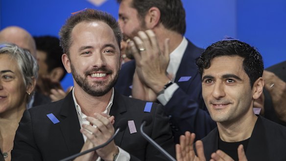 Drew Houston, chief executive officer and co-founder of Dropbox left, and Arash Ferdowsi, co-founder of Dropbox, applaud during the company's initial public offering at the Nasdaq. 