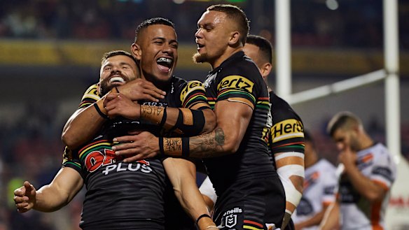 Mansour is mobbed by teammates after a try against the Wests Tigers this year.