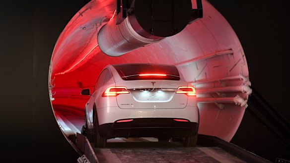 A modified Tesla Model X drives in the tunnel entrance before an unveiling event for the Boring Co.