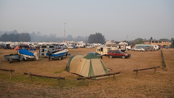 People camp out in an evacuation centre in Batemans Bay on January 04, 2020.  Super Retail Group, the owner of Macpac and Boating Camping Fishing,  has warned investors of a significant hit to sales due to the bushfires.