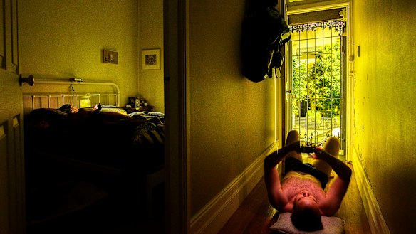 Christopher Pearce has resorted to lying on the floorboards of his home, in Sydney's Newtown, to beat the heat.