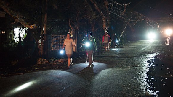 Volunteers and police check on residents after Typhoon Mangkhut in Tuguegarao, Cagayan province, the Philippines, on Saturday.