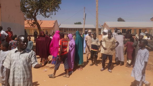Parents gather at the school demanding news of their children.
