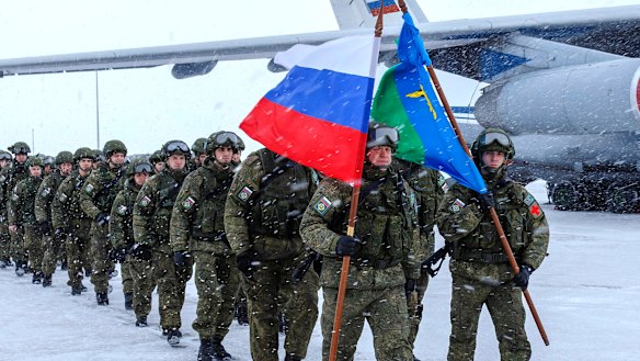 Russian soldiers leave a Russian military plane during the withdrawal of its troops, at an airport outside Moscow.