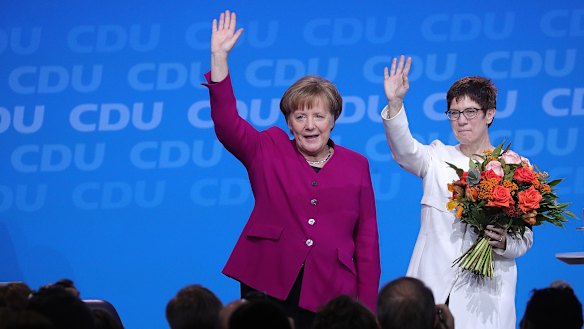 German Chancellor Angela Merkel congratulates her CDU colleague Annegret Kramp-Karrenbauer, now widely tipped as her successor.