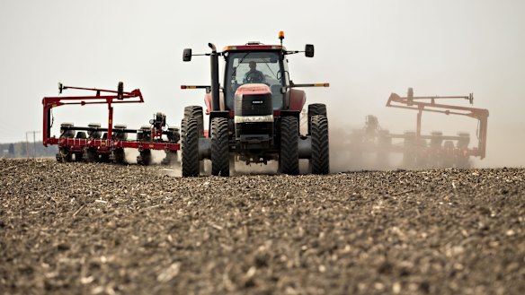 A tractor pulls a planter through a field in Illinois as corn is planted. QBE chief executive Pat Regan said many states across North America had an especially wet spring, which meant a large number of crops were not planted at all or planted late.